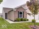 Charming home featuring a brick facade, complemented by lush green lawn and landscaping at 3693 Berkdale Dr, Columbus, IN 47203