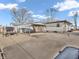Exterior shot of backyard with a detached carport, stone seating area, and paved driveway, ideal for outdoor living at 4592 Gordon Dr, Plainfield, IN 46168