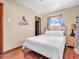 Cozy bedroom featuring hardwood floors, a comfortable bed, and a classic nightstand with a decorative lamp at 4592 Gordon Dr, Plainfield, IN 46168