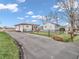 An exterior view of the home with a long driveway and charming yard, nestled in a serene neighborhood setting at 4592 Gordon Dr, Plainfield, IN 46168