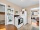 Kitchen with white appliances, built-in shelves, and doorway to adjacent living area at 4592 Gordon Dr, Plainfield, IN 46168