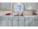 A kitchen with sleek white cabinetry, stainless steel sink, and bright natural light at 4592 Gordon Dr, Plainfield, IN 46168