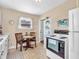 Cozy kitchen with dining area, white appliances, and bright natural light at 4592 Gordon Dr, Plainfield, IN 46168