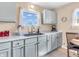 Bright kitchen featuring white cabinets, stainless steel sink and plenty of counter space at 4592 Gordon Dr, Plainfield, IN 46168
