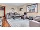 Cozy living room with hardwood floors, a plush gray sofa, an accent chair, and a contemporary coffee table at 4592 Gordon Dr, Plainfield, IN 46168