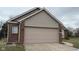 A single Gathering home featuring a large two car garage, brick and siding, and well-maintained landscaping at 4819 Lakestone Dr, Indianapolis, IN 46237