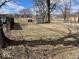 Spacious backyard including a storage shed, mature trees, and chain link fence at 542 N Tremont St, Indianapolis, IN 46222