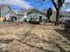 Overview of the backyard showing the back exterior and chain link fence at 542 N Tremont St, Indianapolis, IN 46222