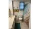 Modest bathroom featuring vanity with marble countertop and decorative shower curtain at 542 N Tremont St, Indianapolis, IN 46222