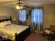 Comfortable bedroom with decorative bed frame and ceiling fan at 542 N Tremont St, Indianapolis, IN 46222
