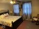 Comfortable bedroom with decorative bed frame and ceiling fan at 542 N Tremont St, Indianapolis, IN 46222