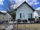 Charming home featuring a quaint, covered front porch and a secure, fenced yard at 542 N Tremont St, Indianapolis, IN 46222