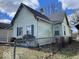 Side and rear view of a home showing siding, windows, and chain link fence at 542 N Tremont St, Indianapolis, IN 46222