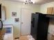 Functional kitchen with a double sink, and a black refrigerator at 542 N Tremont St, Indianapolis, IN 46222