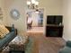 Cozy living room with a fireplace, soft carpet, and comfortable furniture at 542 N Tremont St, Indianapolis, IN 46222
