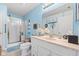 Well-lit bathroom with a shower, vanity, and neutral colored tile at 6103 Lazy Ln, Indianapolis, IN 46259