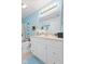 Bright bathroom with blue walls, white vanity, and tile flooring at 6103 Lazy Ln, Indianapolis, IN 46259