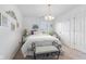 Bright bedroom with carpet floors, a ceiling fan, and a bench at 6103 Lazy Ln, Indianapolis, IN 46259
