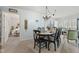 Dining room with chandelier lighting, view to bedroom, and carpet floors at 6103 Lazy Ln, Indianapolis, IN 46259