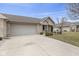 Home with two car garage, stone details and mature landscaping at 6103 Lazy Ln, Indianapolis, IN 46259