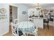 Open concept kitchen with an island, dining table, and view to living room at 6103 Lazy Ln, Indianapolis, IN 46259