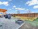 Well-maintained backyard featuring a fire pit, pergola, fence, and a stone-covered patio area, perfect for outdoor enjoyment at 6905 Percy Dr, Indianapolis, IN 46113