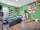 A colorful, quirky room is decorated with posters, plushes, and a beanbag chair at 6905 Percy Dr, Indianapolis, IN 46113