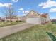Well-kept home featuring a neatly manicured lawn, an American flag, and an attached garage offering curb appeal and convenience at 6905 Percy Dr, Indianapolis, IN 46113