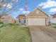 Charming home featuring a well-maintained lawn, two-car garage and American flag at 6905 Percy Dr, Indianapolis, IN 46113