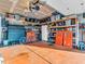 Bright garage featuring a workbench, storage shelves, tools, and a bicycle offering space for projects and organization at 6905 Percy Dr, Indianapolis, IN 46113