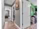 Hallway featuring multiple doors leading to rooms, neutral wall paint and natural wood flooring at 6905 Percy Dr, Indianapolis, IN 46113