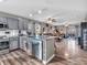Open kitchen with gray cabinetry, granite countertops, stainless steel appliances and modern fixtures at 6905 Percy Dr, Indianapolis, IN 46113
