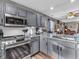 Modern kitchen featuring gray cabinets, granite countertops, stainless steel appliances, and subway tile backsplash at 6905 Percy Dr, Indianapolis, IN 46113