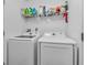 Bright laundry room featuring a new, modern white washer and dryer set at 6905 Percy Dr, Indianapolis, IN 46113