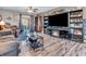 Cozy living room with a fireplace, entertainment center, and a sliding glass door to outdoor patio at 6905 Percy Dr, Indianapolis, IN 46113