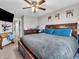 A cozy main bedroom featuring a large bed, dark wood furniture, and a ceiling fan at 6905 Percy Dr, Indianapolis, IN 46113