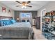 An inviting main bedroom featuring a ceiling fan and a large window providing natural light at 6905 Percy Dr, Indianapolis, IN 46113
