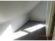 Attic room features an open floor plan and natural light with neutral color palette at 711 W Centennial Ave, Muncie, IN 47303