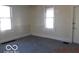 Bright bedroom featuring carpet flooring and two windows that provide natural light at 711 W Centennial Ave, Muncie, IN 47303