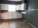 Functional kitchen with ample counter space, white cabinets, and a view of the backyard at 711 W Centennial Ave, Muncie, IN 47303