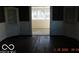 Inviting living room featuring hardwood floors, white trim, and a connecting doorway at 711 W Centennial Ave, Muncie, IN 47303