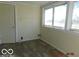 A light-filled sunroom or enclosed porch featuring vinyl flooring and large windows at 711 W Centennial Ave, Muncie, IN 47303