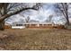 Backyard featuring a brick home, screened-in porch, mature trees, and a fenced perimeter at 7671 Sherry Ln, Brownsburg, IN 46112