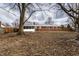 Large backyard featuring a brick home, a screened in porch, and several large trees at 7671 Sherry Ln, Brownsburg, IN 46112