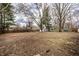 Large backyard with a wooden fence, mature trees, and a storage shed at 7671 Sherry Ln, Brownsburg, IN 46112
