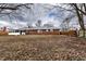 Large backyard with a brick home, screened in porch, and mature trees at 7671 Sherry Ln, Brownsburg, IN 46112