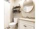 Bright bathroom featuring a vanity with granite countertop, a mirror, and a toilet at 7671 Sherry Ln, Brownsburg, IN 46112