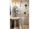 Bathroom with pedestal sink and tiled shower at 7671 Sherry Ln, Brownsburg, IN 46112