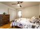 Bedroom with hardwood floors, ceiling fan, and dresser at 7671 Sherry Ln, Brownsburg, IN 46112