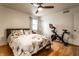 Bedroom with hardwood floors, ceiling fan, exercise bike and lots of natural light at 7671 Sherry Ln, Brownsburg, IN 46112